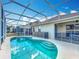 Refreshing swimming pool in a screened enclosure, surrounded by lush landscaping at 331 Henley Cir, Davenport, FL 33896