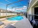 Sparkling pool in a screened enclosure, perfect for relaxing and entertaining at 331 Henley Cir, Davenport, FL 33896