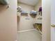 Walk-in closet with white wire shelving and clothing and ironing board at 331 Henley Cir, Davenport, FL 33896