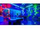 Bright game room with air hockey, pool table, gaming chairs, and neon lighting at 3348 Lilac Way, Davenport, FL 33897