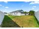 Large, green backyard with white fencing creating a private outdoor space at 3414 Willow Branch Ln, Kissimmee, FL 34741