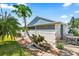 Backyard oasis with a lush papaya tree and outdoor dining area at 3414 Willow Branch Ln, Kissimmee, FL 34741