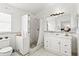 Bathroom with a shower and vanity featuring a white basin sink and cabinets at 3414 Willow Branch Ln, Kissimmee, FL 34741