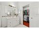 Bathroom with white vanity and walk-in closet at 3414 Willow Branch Ln, Kissimmee, FL 34741