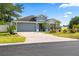 Charming single-story home with a well-maintained front yard and attached two-car garage at 3414 Willow Branch Ln, Kissimmee, FL 34741