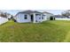 Spacious backyard with lush lawn and covered patio, ideal for outdoor activities at 3431 Perching Rd, St Cloud, FL 34772