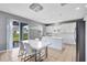 Dining room area with modern white table set and a view of the backyard at 3431 Perching Rd, St Cloud, FL 34772