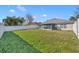 Large fenced backyard with lush green grass, offering ample space for recreation and relaxation at 3642 Doe Run Dr, St Cloud, FL 34772