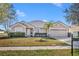 Charming single-story home with a well-manicured front yard, and a two car garage at 3642 Doe Run Dr, St Cloud, FL 34772