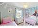 Charming bedroom with two twin beds, fairy lights, and themed mural at 3939 Calabria Ave, Davenport, FL 33897