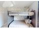 A gray bunkbed sits in front of the wallpapered accent wall at 3939 Calabria Ave, Davenport, FL 33897