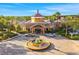 Stunning exterior view of the Regal Palms clubhouse, surrounded by lush greenery and palm trees at 3939 Calabria Ave, Davenport, FL 33897