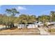 An aerial view of a quaint one-story home showcasing mature trees and a covered parking area at 415 N Winter Park Dr, Casselberry, FL 32707