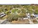 Aerial view of a white single Gathering home with a gray roof surrounded by lush foliage at 415 N Winter Park Dr, Casselberry, FL 32707