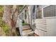 Exterior steps lead to the home's entrance, framed by trees at 415 N Winter Park Dr, Casselberry, FL 32707