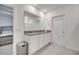 Bathroom showcasing double sinks with granite countertop and a large mirror at 417 Noble Ave, Davenport, FL 33837