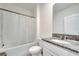 Bright bathroom featuring a granite vanity and shower with curtain rod at 417 Noble Ave, Davenport, FL 33837