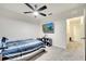 Bright bedroom with a TV, ceiling fan, and a view to the hallway at 417 Noble Ave, Davenport, FL 33837