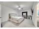 Cozy bedroom showcasing a bed, ceiling fan and an entrance to bathroom at 417 Noble Ave, Davenport, FL 33837