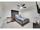 Comfortable bedroom featuring a ceiling fan and a striped-patterned bedspread at 417 Noble Ave, Davenport, FL 33837