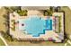 Aerial view of the geometric community pool with ample lounge seating and tropical landscaping at 417 Noble Ave, Davenport, FL 33837