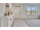 Bright entryway featuring tile floors, white walls, a decorative console table, and a view through the window at 417 Noble Ave, Davenport, FL 33837