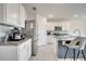 Stylish kitchen with stainless steel appliances, granite countertops, white cabinets, and an island with bar stool seating at 417 Noble Ave, Davenport, FL 33837