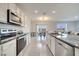 Modern kitchen with granite countertops, stainless steel appliances and adjacent dining area at 417 Noble Ave, Davenport, FL 33837