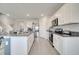 Bright kitchen features white cabinets, granite countertops, stainless steel appliances and an island with bar stool seating at 417 Noble Ave, Davenport, FL 33837