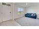 Cozy living room featuring tile floors, a bright window, and a comfortable blue sofa at 417 Noble Ave, Davenport, FL 33837