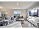 Bright and airy living room features tile floors, a large window, and a comfortable sectional sofa at 417 Noble Ave, Davenport, FL 33837