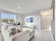 Bright living room features tile floors, a large window, and a comfortable gray sectional sofa at 417 Noble Ave, Davenport, FL 33837