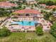 Aerial view of a community clubhouse and swimming pool surrounded by lush landscaping and homes at 4506 Alberto Cir, Kissimmee, FL 34746