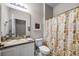 Standard bathroom featuring a vanity with sink, toilet, and a shower with patterned curtain at 4506 Alberto Cir, Kissimmee, FL 34746