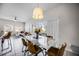 Open dining area featuring modern table with seating and view of the outdoor pool area through sliding glass doors at 4506 Alberto Cir, Kissimmee, FL 34746