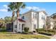 Two-story home featuring a red tile roof, covered entry, screened in porch, and a lush green lawn at 4506 Alberto Cir, Kissimmee, FL 34746