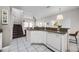 Open kitchen with granite countertops and white cabinetry, seamlessly connected to a staircase at 4506 Alberto Cir, Kissimmee, FL 34746