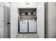 A laundry closet with a stacked washer and dryer and some shelving for linens at 4506 Alberto Cir, Kissimmee, FL 34746