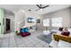 Open concept living room featuring stairs to second floor, tile floors, a ceiling fan and natural lighting at 4506 Alberto Cir, Kissimmee, FL 34746