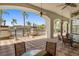 Outdoor covered seating area with tables and chairs overlooking the lake with palm trees at 4506 Alberto Cir, Kissimmee, FL 34746