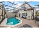 Screened-in pool area with brick pavers and outdoor seating, perfect for relaxation at 4506 Alberto Cir, Kissimmee, FL 34746