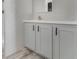 Bathroom vanity features gray shaker cabinets, a white countertop, and modern faucet at 4628 Chicadee Ave, Orlando, FL 32812