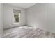 Neutral bedroom with wood-look flooring and a large window at 4628 Chicadee Ave, Orlando, FL 32812