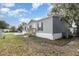 Exterior view featuring a gray home with new wooden steps and a well-maintained lawn at 4628 Chicadee Ave, Orlando, FL 32812