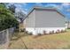 Exterior view of gray-sided house with fenced-in yard and small deck at 4628 Chicadee Ave, Orlando, FL 32812