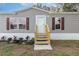 Charming home exterior with gray siding, red shutters, and well-manicured landscaping at 4628 Chicadee Ave, Orlando, FL 32812