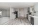 Modern kitchen with gray cabinetry, black appliances, and an open layout to the living room at 4628 Chicadee Ave, Orlando, FL 32812