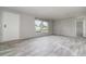 Bright living room featuring gray floors, neutral paint, and plenty of natural light at 4628 Chicadee Ave, Orlando, FL 32812