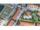 An aerial perspective showing the pool, tennis court, and neighboring townhome communities at 4846 Coral Castle Dr, Kissimmee, FL 34746