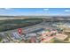Drone photo of the real estate highlighting nearby highway, pond, pool, and surrounding neighborhood at 4846 Coral Castle Dr, Kissimmee, FL 34746